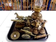 A tray containing antique and later brass ware to include converted brass oil lamp, candlesticks,