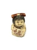 A carved Chinese bone netsuke - Lady with hair bow