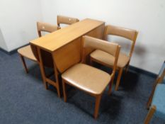 A 20th century teak drop leaf table and four chairs