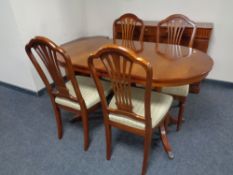 An inlaid yew wood four door break front sideboard together with matching oval extending pedestal
