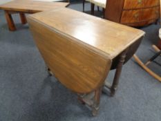 An Edwardian oak gate leg table