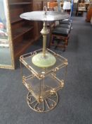 A 20th century brass and glass revolving two tier occasional table together with a further gilt and