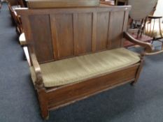 A 19th century panel back storage settle