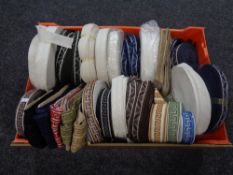 A basket containing a quantity of spools of Silver Cross pram trim