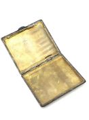 A silver cigarette case with engine turned decoration,