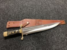 A large hunting knife in leather sheath