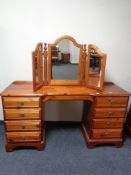 A Ducal pine eight drawer dressing chest with triple mirror