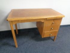 A 20th century oak single pedestal desk fitted three drawers and a slide