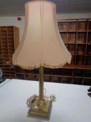 A brass Corinthian column table lamp with shade