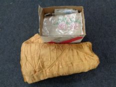 A mid 20th century floral patterned quilt together with a box containing assorted table linens