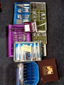 A box containing boxed mid 20th century stainless steel cutlery to include Oneida and Bermuda