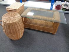 A wicker glass topped conservatory table together with two wicker laundry baskets