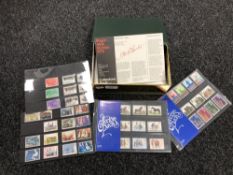 A box containing Royal Mail first day covers and Hectors packs British Mint stamps