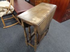 An Edwardian oak gate leg table