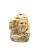 A carved Chinese bone netsuke - Village elder with scroll