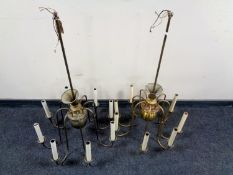 A pair of brass eight branch chandeliers