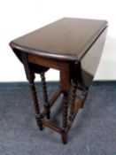 An oak barley twist drop leaf table