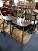 A pair of Ercol spindle back dining chairs together with a stained elm low coffee table