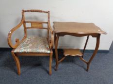 An Edwardian shaped oak occasional table together with an inlaid mahogany scroll arm armchair