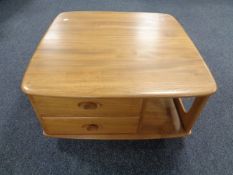 An Ercol elm Pandora's box coffee table on castors