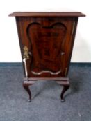 An Edwardian bedside cabinet on cabriole legs