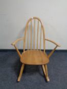 An Ercol elm and beech spindle backed rocking chair