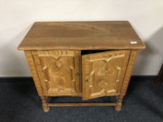 A Continental oak double door side cabinet