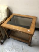 A contemporary begere and glass topped lamp table