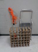 A wooden and metal wine rack together with a black and decker strimmer and folding steps
