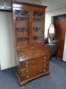 An early 19th century mahogany bureau bookcase on bracket feet