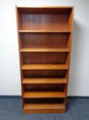 A set of teak open bookshelves