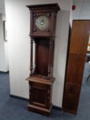 An Edwardian oak longcase clock with pendulum and weights