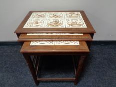 A nest of three mid 20th century teak tile top tables