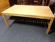 A continental pine effect coffee table with webbed strapping undershelf
