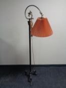 An early 20th century brass floor lamp on cast iron base