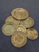 A box containing brass wall plaques, tapestry depicting a coat of arms,