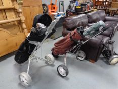 Two folding golf trolleys together with two golf bags containing assorted irons and drivers to