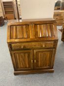 An oak linen fold bureau