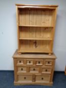 A set of contemporary pine open bookshelves together with a chest of nine drawers