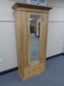 A pine single mirror door wardrobe