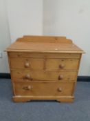 A pine four drawer chest