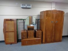 A four piece 1930's walnut bedroom suite comprising of double door wardrobe, dressing table,