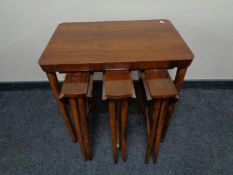 A walnut table fitted three tables beneath