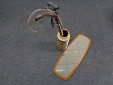 A 1970's frameless mirror mounted on teak board together with a West German stick pot containing