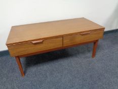 A teak effect coffee table fitted two drawers