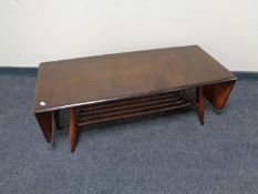 An ercol dark elm drop leaf coffee table fitted under shelf