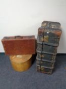 A leather briefcase together with a shipping trunk and a further circular luggage case