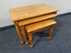 A contemporary pine nest of three tables