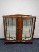 An Art Deco glazed walnut display cabinet