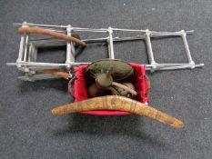 A wicker basket containing boomerang, copper teapot,